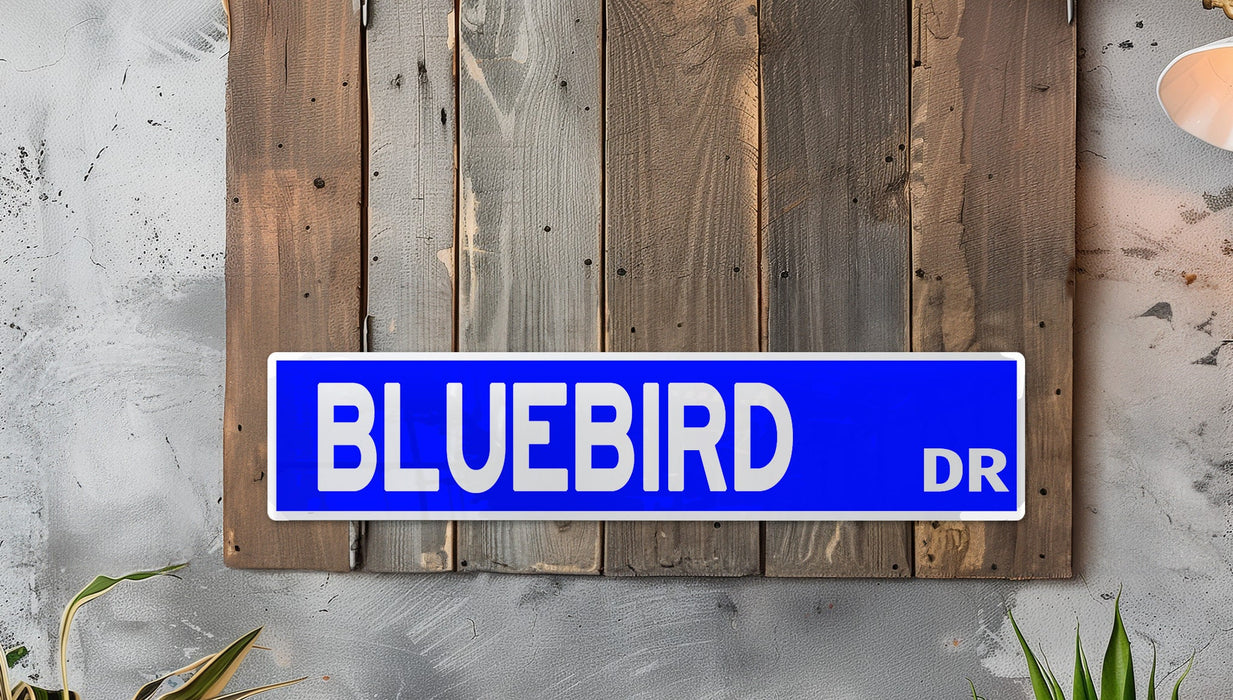 a blue street sign mounted to a wooden wall