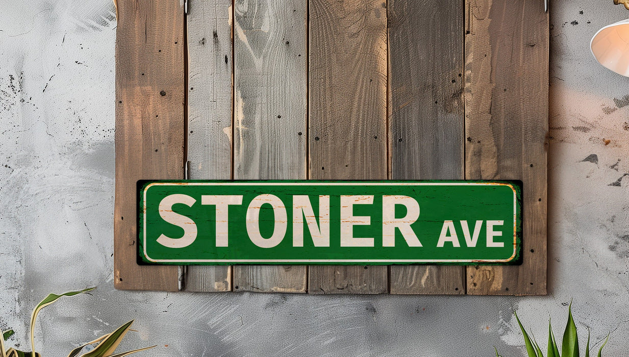 a green stoner ave sign mounted to a wooden wall