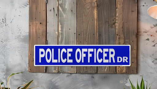 a police officer sign mounted to a wooden wall