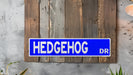 a blue street sign mounted to the side of a wooden wall
