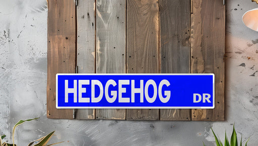 a blue street sign mounted to the side of a wooden wall