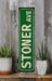a green sign sitting on top of a wooden shelf