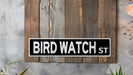 a bird watch street sign mounted to a wall