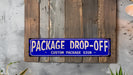 a blue package drop - off sign mounted on a wooden wall