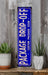 a blue sign sitting on top of a wooden shelf