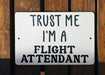 a sign that says trust me i'm a flight attendant