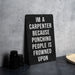 a sign on a table that says i'm a carpenter because punching people is
