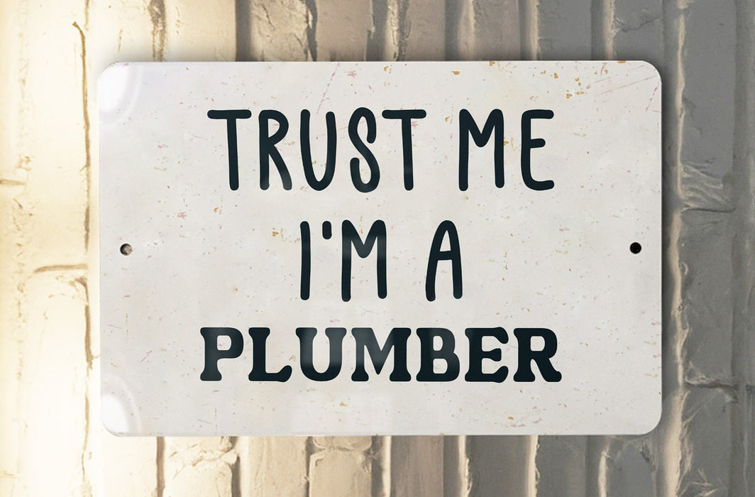 a white sign that says trust me i'm a plumber