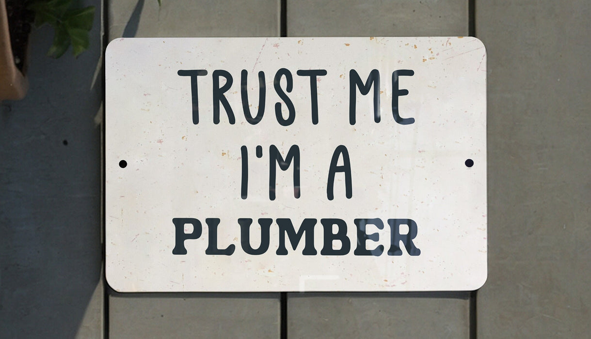 a white sign that says trust me i'm a plumber