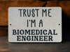 a sign that says trust me i'm a biomedical engineer