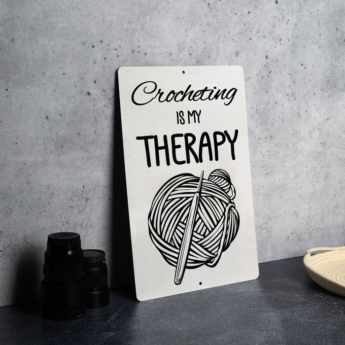 a picture of a sign that says crocheting is my therapy