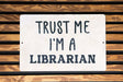 a sign that says trust me i'm a librarian