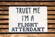 a sign that says trust me i'm a flight attendant