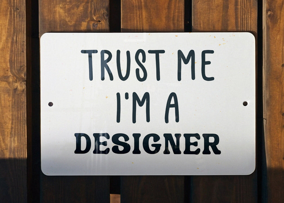 a sign that says trust me i'm a designer