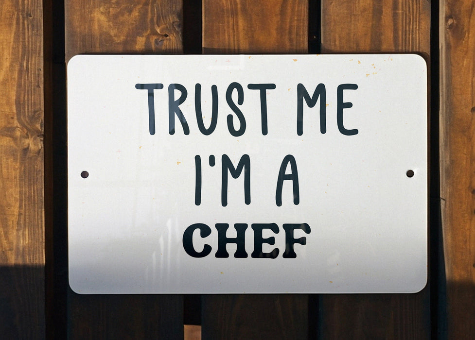 a white sign that says trust me i'm a chef