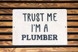 a sign that says trust me i'm a plumber