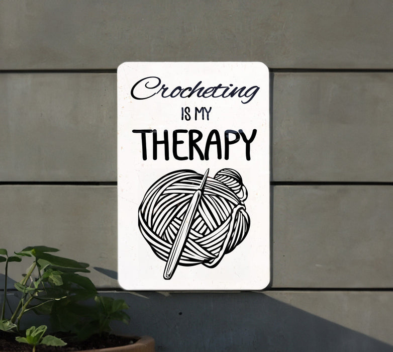 a white sign with a ball of yarn on it
