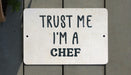 a white sign that says trust me i'm a chef