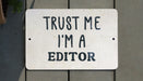 a white sign that says trust me i'm a editor