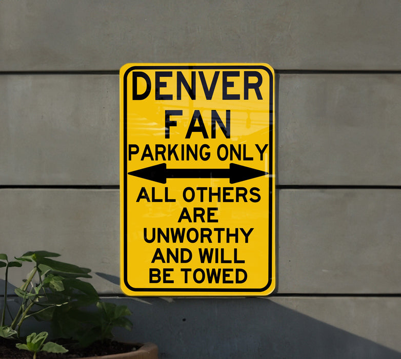 a yellow sign that says denver fan parking only all others are unworthyly and