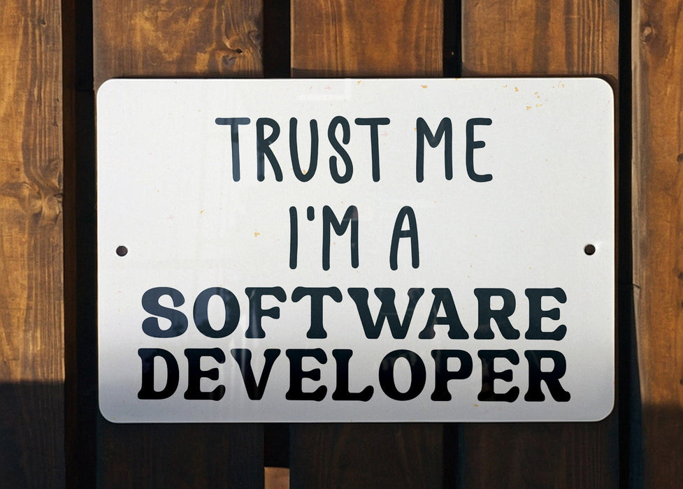 a white sign that says trust me i'm a software developer