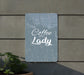 a sign that reads coffee lady next to a potted plant