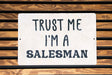 a sign that says trust me i'm a salesman
