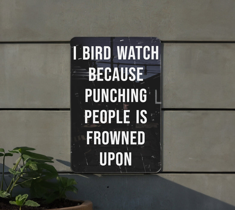 a sign on the side of a building that says i bird watch because punching people