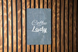 a sign on a wooden wall that says coffee lady