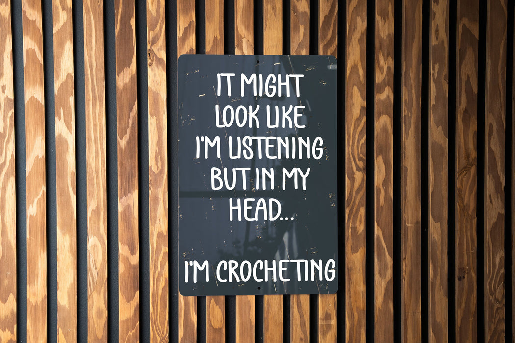 a sign on a wooden wall that says it might look like i'm listening
