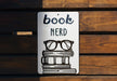 a book nerd sign on a wooden bench