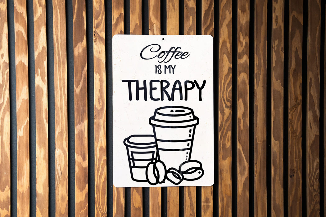 a sign on a wooden wall that says coffee is my therapy