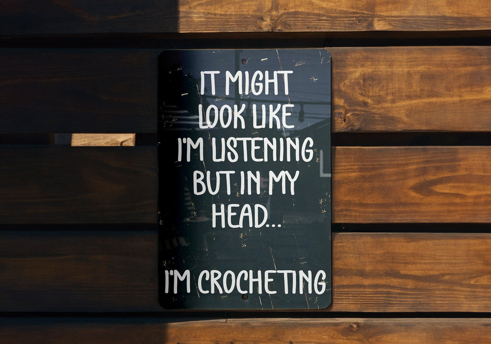 a sign on a wooden bench that says it might look like i'm listening