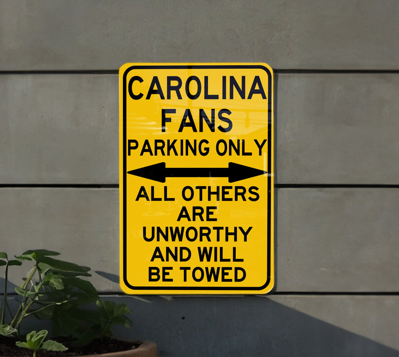 a yellow parking only sign on the side of a building