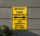 a yellow street sign on the side of a building