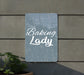 a sign that says baking lady next to a potted plant