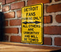 a yellow sign on a brick wall that says detroit fans parking only all others are