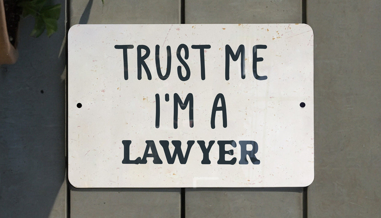 a white sign that says trust me i'm a lawyer