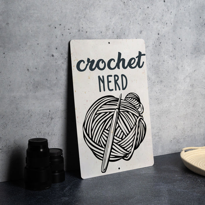a sign that says crochet nerd with a ball of yarn