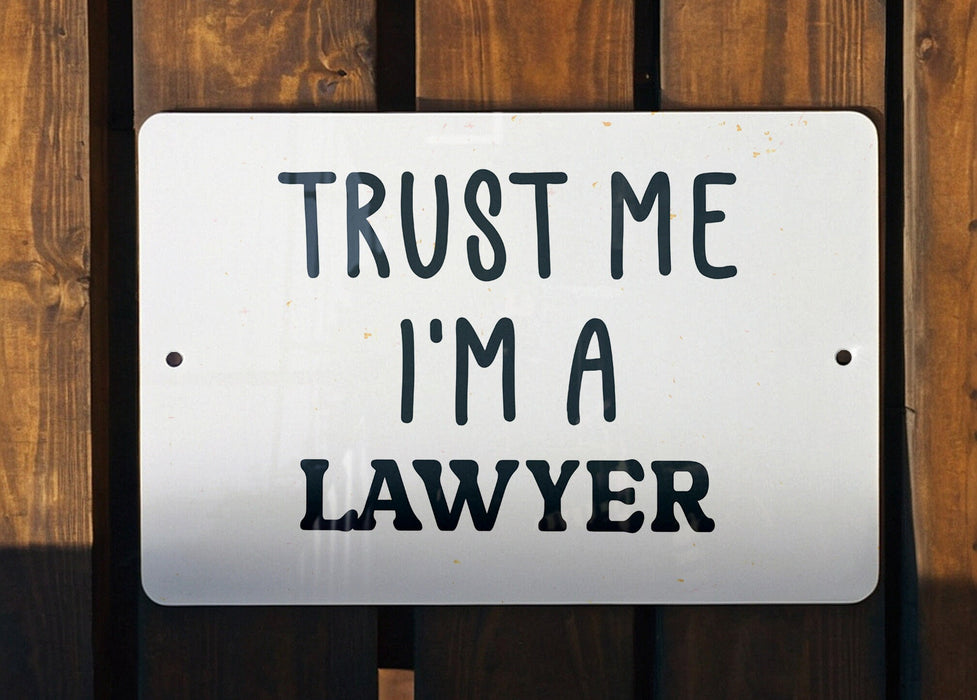 a white sign that says trust me i'm a lawer