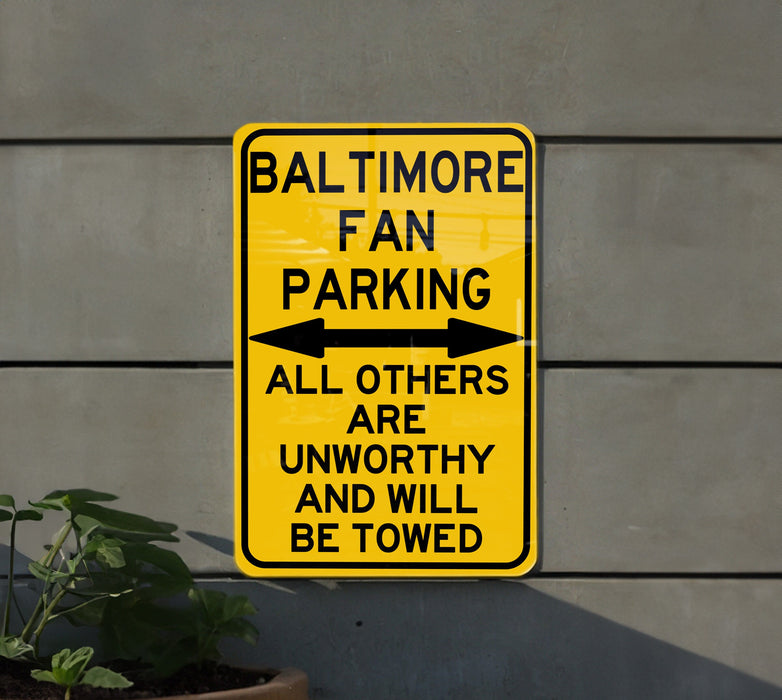 a yellow street sign that says baltimore fan parking all others are unworthyly and