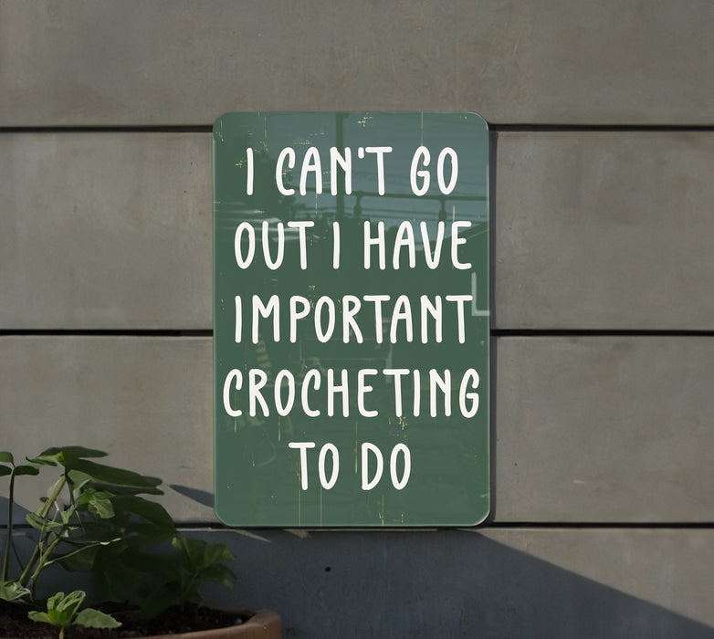 a green sign that says i can't go out i have important croche