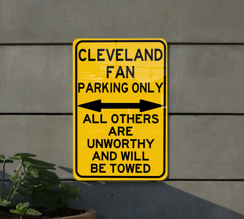 a yellow parking only sign on the side of a building