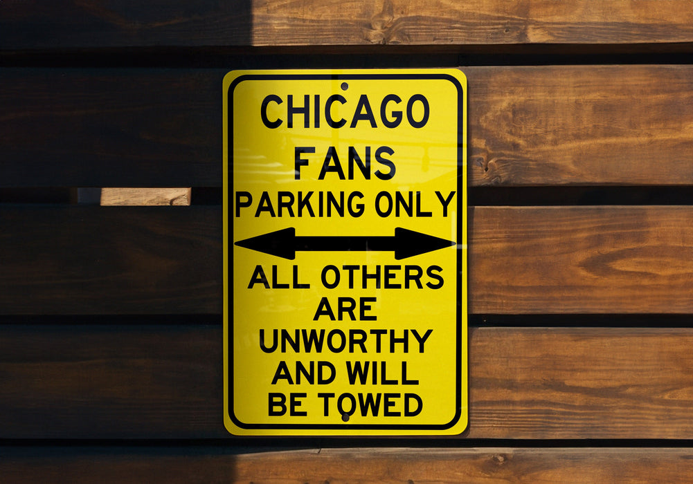 a yellow chicago fans parking only sign on a wooden wall