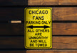 a yellow chicago fans parking only sign on a wooden wall