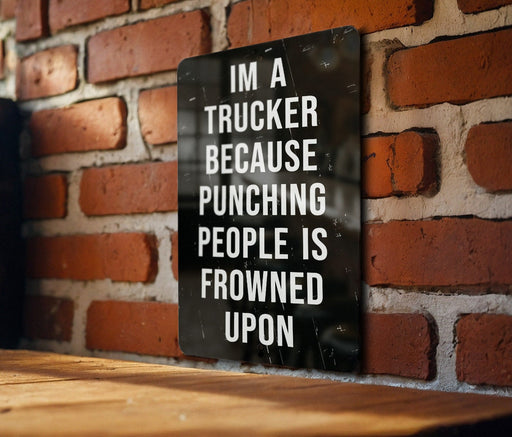 a sign on a brick wall that says i'm a trucker because punching