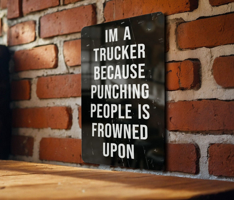 a sign on a brick wall that says i'm a trucker because punching
