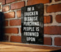 a sign on a brick wall that says i'm a trucker because punching