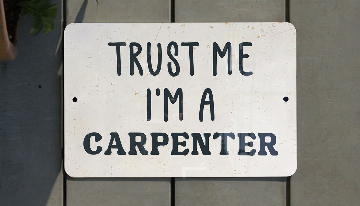a white sign that says trust me i'm a carpenter