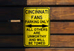 a yellow street sign on a wooden wall